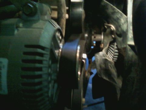 1996 Ford Bronco - This image shows a close-up view of the engine's alternator and belt system.