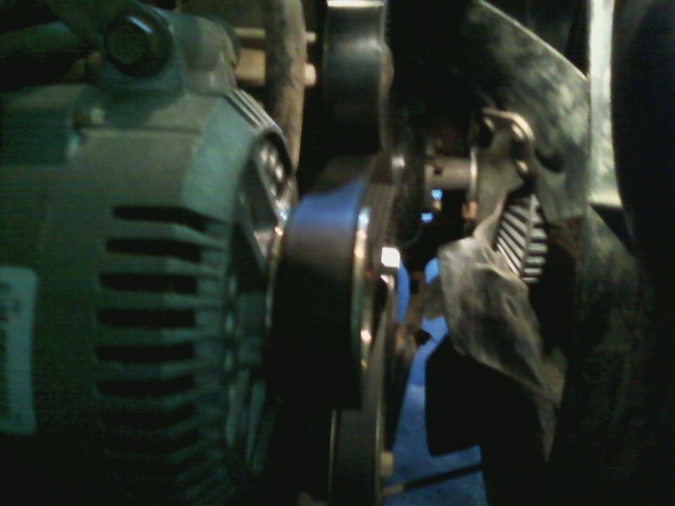 Close-up of vehicle's alternator and serpentine belt system