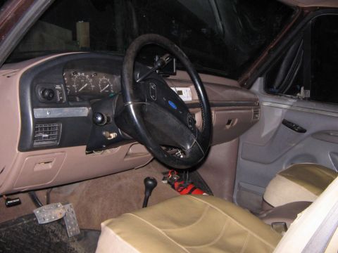 1992 Ford Bronco - The interior of a 1992 Ford Bronco, tan seats and a brown dashboard with visible gauges.