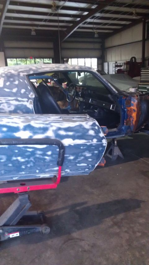 1973 Chevrolet Camaro - This 1973 Chevrolet Camaro is undergoing bodywork in a shop, showing primer and exposed metal.