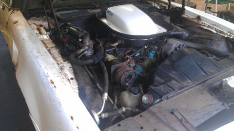 1973 Chevrolet Camaro - Car engine bay with a prominent air cleaner labeled '455'. The vehicle appears to be in a state of disrepair.
