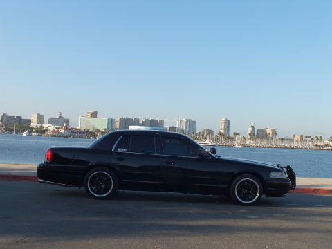 2003 Ford Crown Victoria - Lowered Crown Victoria shot in profile against the marina and city skyline, Marauder side badge visible