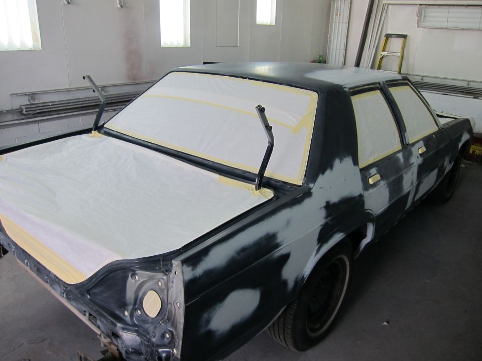 1991 Ford Crown Victoria LTD in body shop, rear quarter view, masked for paint