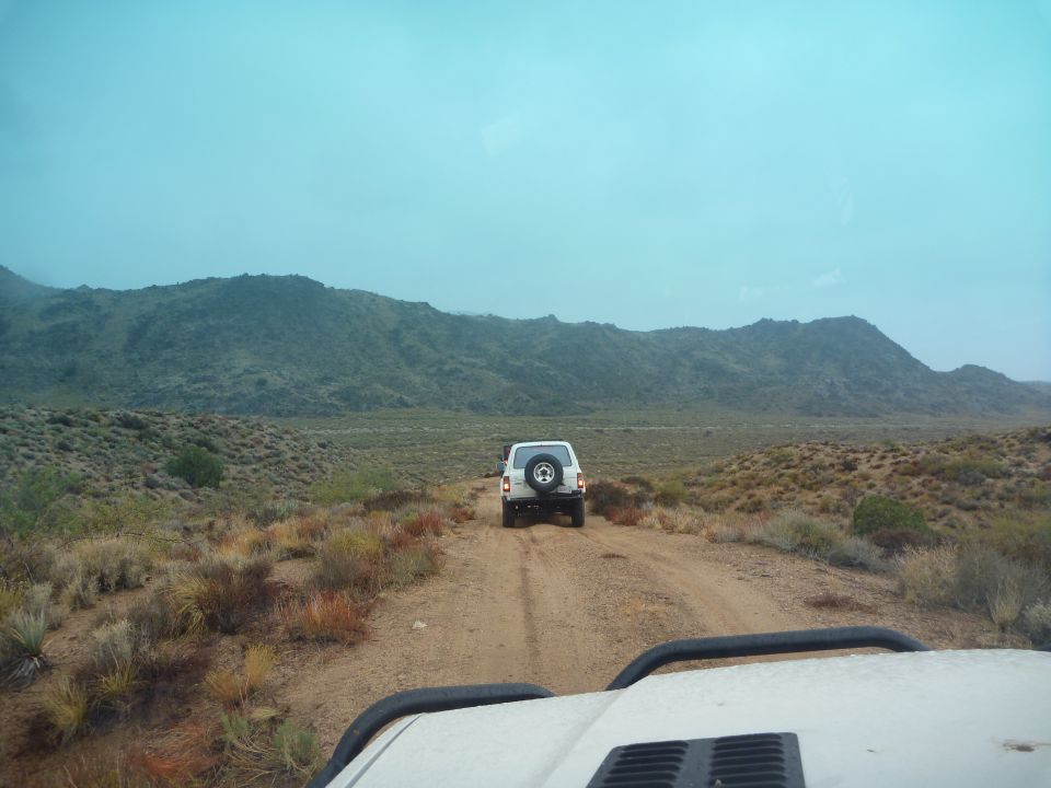 1985 Toyota 4Runner following another SUV on a desert dirt road