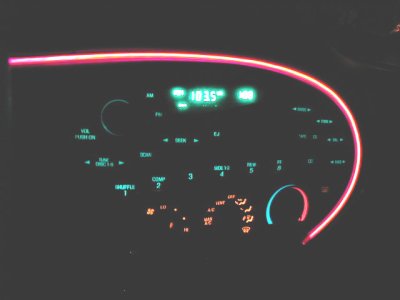1997 Ford Taurus - Dashboard interior of a 1997 Ford Taurus, illuminated controls and a red accent light.