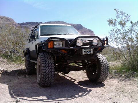 1985 Toyota 4Runner - Modified 1985 Toyota 4Runner parked in a desert landscape under a clear blue sky.
