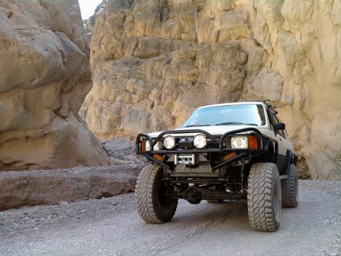 1985 Toyota 4Runner - This modified SUV navigates a narrow canyon with towering rock walls.