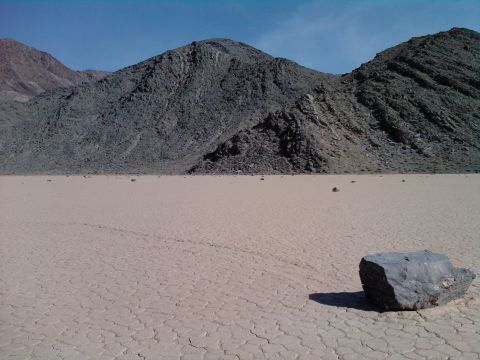 1985 Toyota 4Runner - A vast, dry lake bed stretches towards mountains under a clear blue sky.