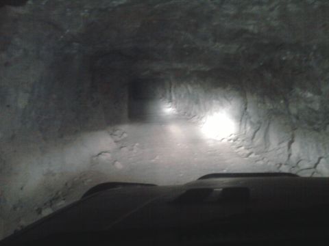 1985 Toyota 4Runner - The vehicle's headlights illuminate the rough walls of a narrow tunnel.