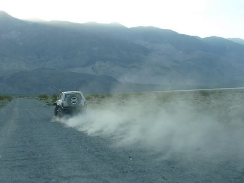1985 Toyota 4Runner - A white 1985 Toyota 4Runner kicks up dust on a desolate road in Death Valley.