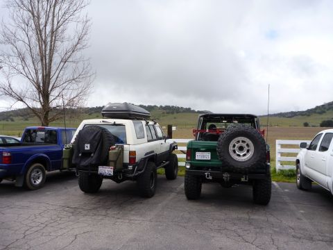 1985 Toyota 4Runner - A white 1985 Toyota 4Runner is parked next to a green SUV and a blue pickup truck.
