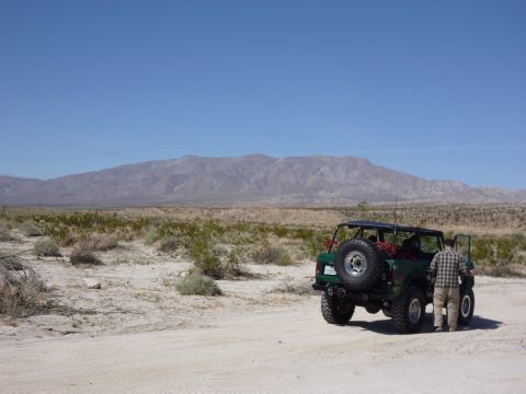 1985 Toyota 4Runner - A 1985 Toyota 4Runner is parked in a desert with mountains in the background.