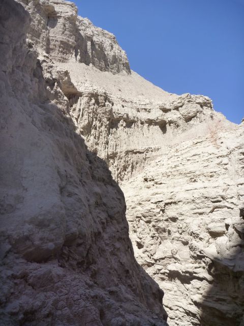 1985 Toyota 4Runner - The image shows a natural landscape with layered rock formations and a bright blue sky above.