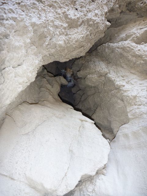 1985 Toyota 4Runner - A natural rock formation with a dark crevice, a website logo at the bottom.