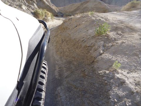 1985 Toyota 4Runner - Driving through a narrow desert canyon on a dirt trail.