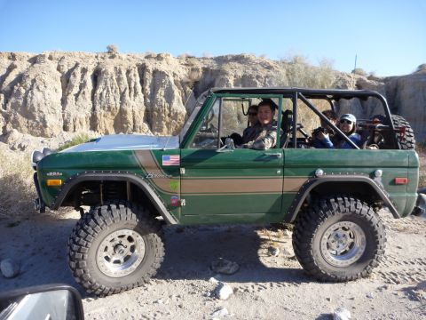 1985 Toyota 4Runner - This modified Ford Bronco, likely from the 1970s, is equipped for off-road adventures in a desert environment.