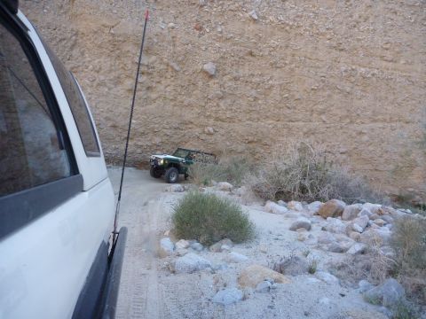 1985 Toyota 4Runner - A white vehicle is parked on a dirt road, with a green off-road vehicle ahead.