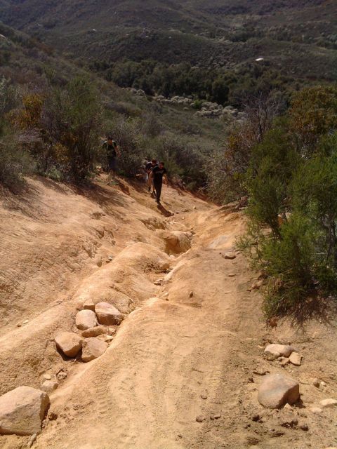 1985 Toyota 4Runner - Hikers navigate a challenging off-road path through a , natural landscape.