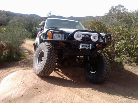 1985 Toyota 4Runner - This modified 1985 Toyota 4Runner navigates an off-road trail, its build and aftermarket enhancements.