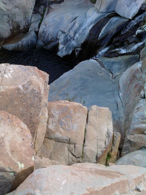 1985 Toyota 4Runner - Natural rock formations with a small waterfall and pool, viewed from above.