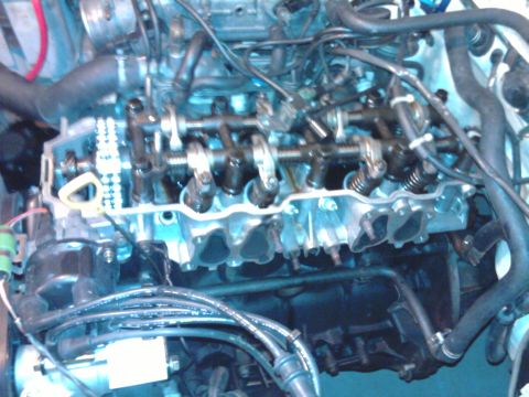1985 Toyota 4Runner - Close-up view of an engine's internal components, including the camshaft and timing chain, with the valve cover removed.