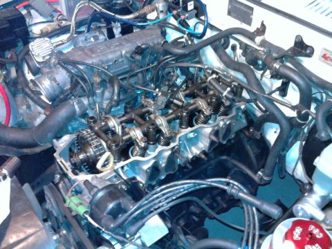 1985 Toyota 4Runner - Close-up view of an engine with the valve cover off, revealing internal components.