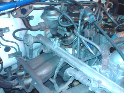 1985 Toyota 4Runner - Close-up view of an engine bay with numerous hoses and wires.