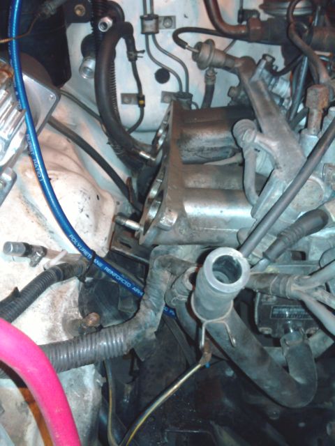 1985 Toyota 4Runner - A close-up view of various engine components and hoses within a vehicle's engine bay.