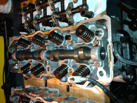 1985 Toyota 4Runner - Close-up view of an engine's cylinder head, revealing internal components like the camshaft and valves.