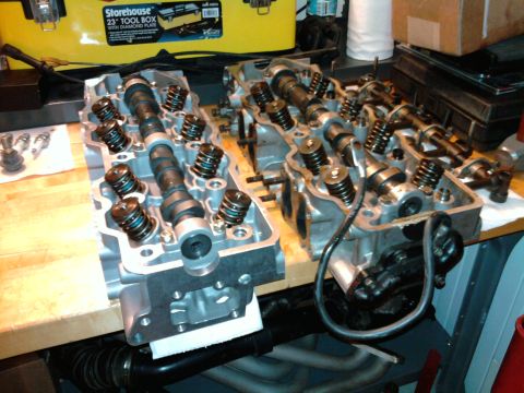 1985 Toyota 4Runner - Engine cylinder heads are shown on a workbench, likely during a rebuild or repair process.