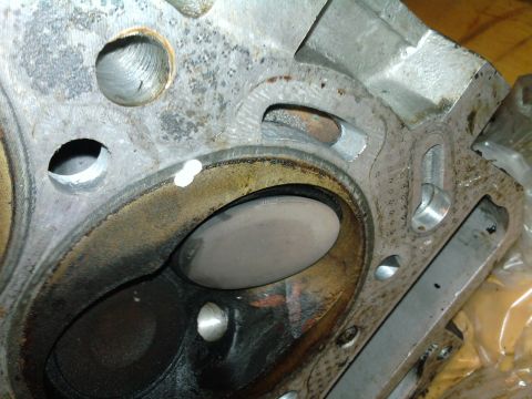 1985 Toyota 4Runner - This is a close-up view of an engine cylinder head, showing a valve within its chamber. The part appears to have seen significant use.