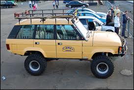 1990 Chevrolet Suburban - Modified off-road SUV with Camel Trophy branding, likely from the 1980s.