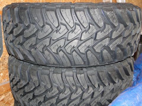 1978 Ford Bronco - Two stacked off-road tires are shown, a deep, aggressive tread pattern for off-road traction.