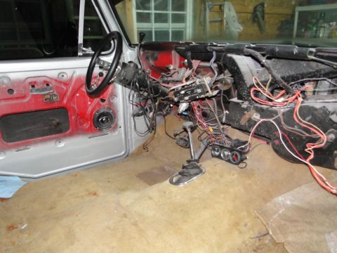 1978 Ford Bronco - The interior of a vehicle shows exposed wiring and a disassembled dashboard, indicating ongoing work or repair.