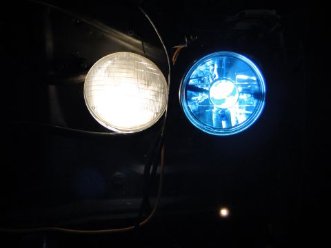 1978 Ford Bronco - Close-up of two vehicle headlights, one emitting white light and the other blue light.