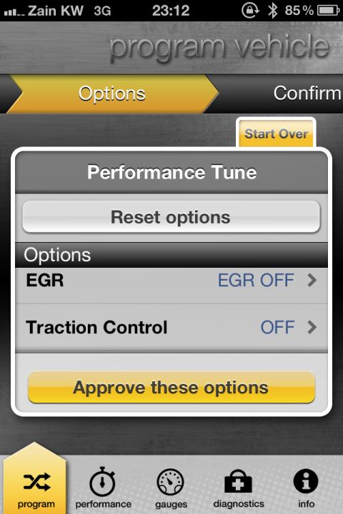 2001 Mercury Grand Marquis - A smartphone screen shows a performance tuning application with options to adjust EGR and traction control settings.