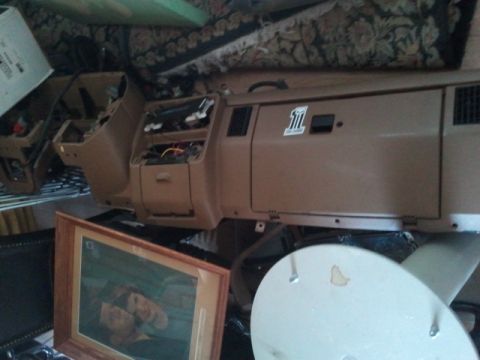 1993 Ford Bronco - Disassembled vehicle interior components are visible, along with a framed picture and SuperMotors watermark.