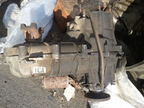 1993 Ford Bronco - This is a transfer case, likely from a 4WD vehicle, with some visible wiring and a sticker on the housing.