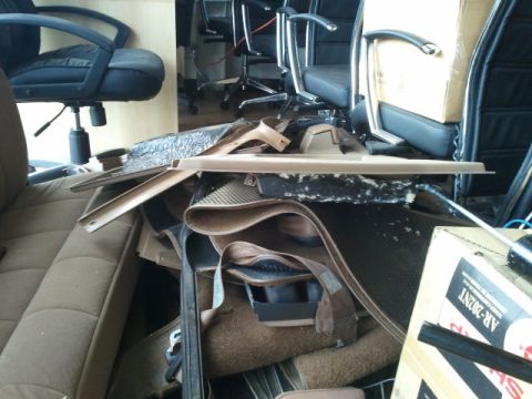 1993 Ford Bronco - Car interior parts are piled up, obscuring the view of any vehicle.