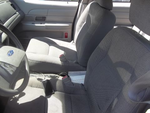 2004 Ford Crown Victoria - Interior view of a 2004 Ford Crown Victoria, highlighting the front seating area and dashboard details.
