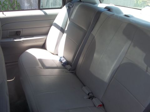 2004 Ford Crown Victoria - Interior view of a car's rear seat and door panel.