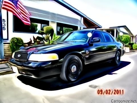 2003 Ford Crown Victoria - Mercury full-size sedan with waterfall grille parked by an American flag; image stamped 09/02/2011, address 535.