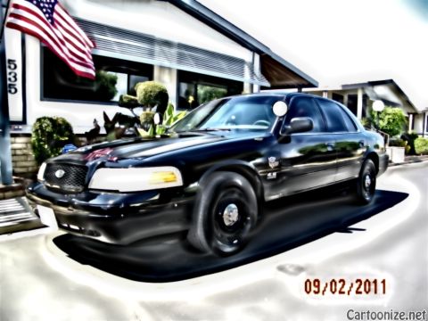 2003 Ford Crown Victoria - Mercury sedan with chrome waterfall grille and 4.6 fender badge; US flag and 535 address behind, dated 09/02/2011.