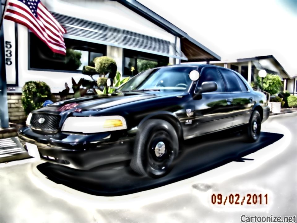 Black Mercury Grand Marquis front three-quarter showing 4.6 badge and waterfall grille by US flag, dated 09/02/2011