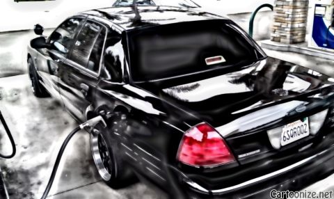 2003 Ford Crown Victoria - Stylized shot of a black full-size sedan at a pump; fuel hose attached, plate 6SOROOZ visible on rear.