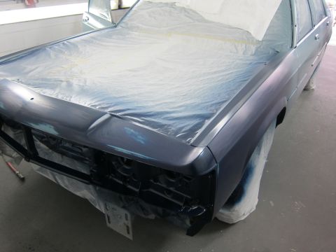 1991 Ford LTD Crown Victoria - A Ford Crown Victoria is being prepped for painting, with its hood covered in protective plastic.