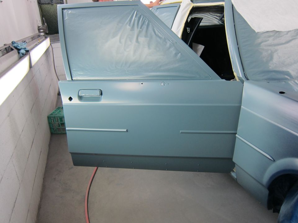 Car door and fender being painted, with door open