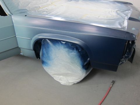 1991 Ford LTD Crown Victoria - Car bodywork being prepped for paint, showing the fender and door covered in protective sheeting.