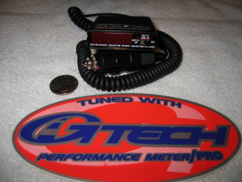 2002 Ford Taurus - A G-Tech Performance Meter Pro device is shown with its accessories and a coin for scale.