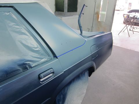 1991 Ford LTD Crown Victoria - A 1991 Ford Crown Victoria LTD's rear quarter panel is covered in plastic and tape, ready for a fresh coat of paint.